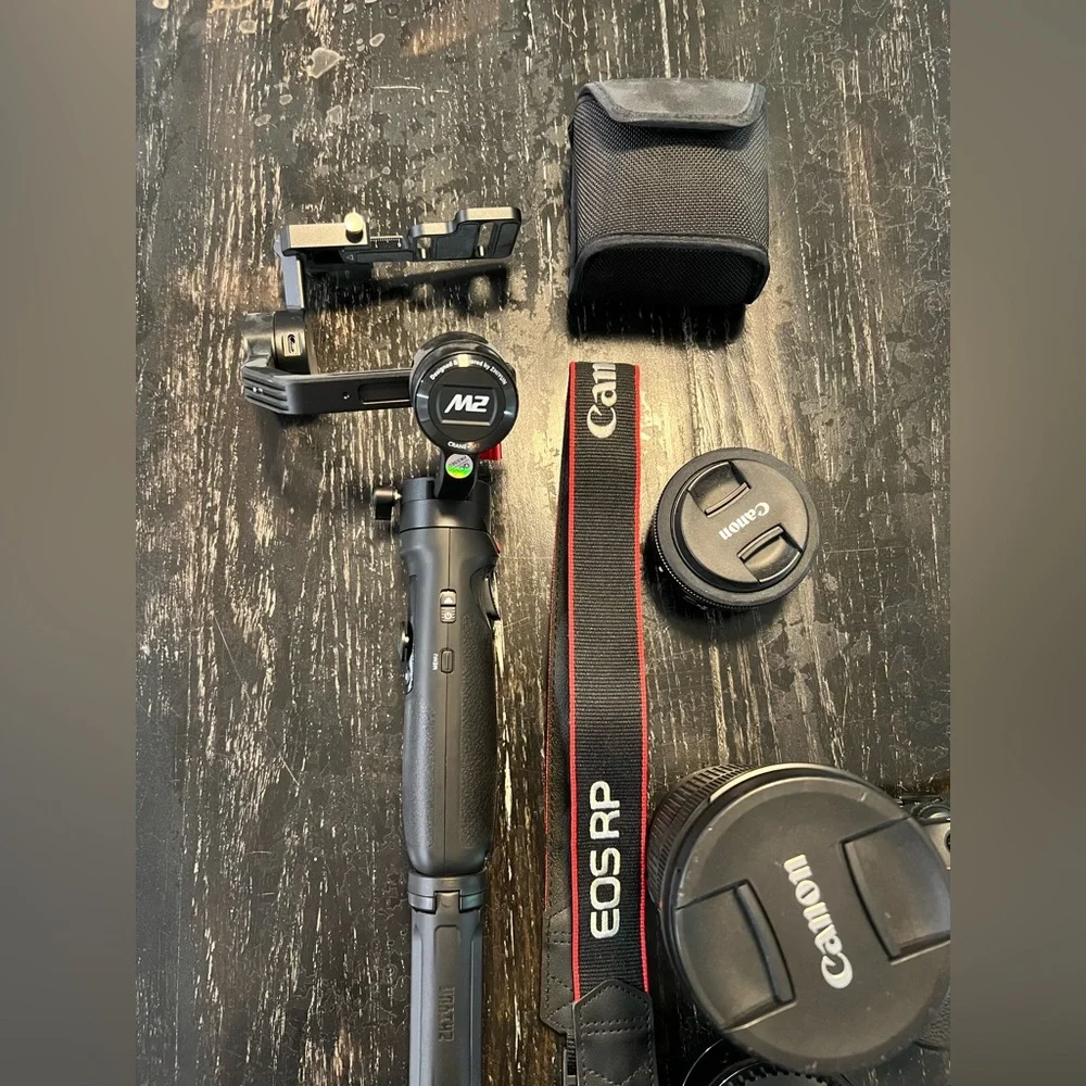 Canon EOS RP with mount adapter, two lenses, gimbal, and strap